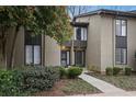 Tan colored exterior of a townhome with manicured landscaping and walkway at 16 Ivy Ne Rdg, Atlanta, GA 30342