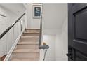 Modern carpeted staircase with dark wood railing leading to upper level at 16 Ivy Ne Rdg, Atlanta, GA 30342