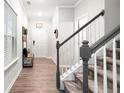 Hallway with staircase and bench in the entry of the home at 319 Pinewood Dr, Woodstock, GA 30189
