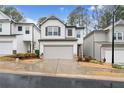 Two story townhome featuring a two car garage and craftsman style architecture at 319 Pinewood Dr, Woodstock, GA 30189