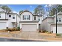 Charming two-story home featuring a well-maintained lawn and a convenient two-car garage at 319 Pinewood Dr, Woodstock, GA 30189