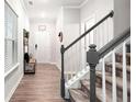 Welcoming foyer with stylish wood flooring, a staircase, and ample natural light at 319 Pinewood Dr, Woodstock, GA 30189