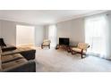 Bright living room featuring a sectional sofa and ample natural light at 790 Oakhaven Dr, Roswell, GA 30075