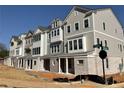 New townhomes with gray siding, brick accents, and well-designed architectural details at 1980 Flying Scotsman Dr # 10, Kennesaw, GA 30144