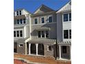 New townhome with gray siding, brick accents, and well-designed architectural details at 1980 Flying Scotsman Dr # 10, Kennesaw, GA 30144
