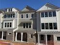 New townhome with gray siding, brick accents, and well-designed architectural details at 1980 Flying Scotsman Dr # 10, Kennesaw, GA 30144