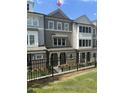 Inviting townhome with a covered entrance, brick detailing, and manicured landscaping, adding to its curb appeal at 1980 Flying Scotsman Dr # 10, Kennesaw, GA 30144