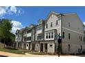Exterior shot of new townhomes featuring grey and white siding, stone accents, and well-maintained landscaping at 1980 Flying Scotsman Dr # 10, Kennesaw, GA 30144