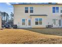 Private backyard with a patio, grassy area, and space for outdoor furniture at 4658 Grand Central Pkwy, Decatur, GA 30035