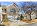 Two-story townhouse with brick exterior, attached garage, and mature trees at 4658 Grand Central Pkwy, Decatur, GA 30035