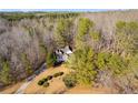 Home surrounded by lush trees, offering privacy at 121 Rachel Blvd, Temple, GA 30179
