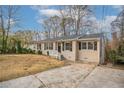 Cozy single story home with driveway, quaint yard and covered front entrance at 3234 Bluebird Ln, Decatur, GA 30032