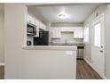 Bright kitchen featuring granite countertops, stainless steel appliances, and white cabinetry at 3234 Bluebird Ln, Decatur, GA 30032