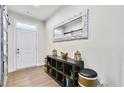 Bright entryway with a console table, mirror, and wood-look floors at 727 Coneflower Way, Mcdonough, GA 30253