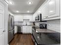 Well-maintained kitchen featuring white cabinets, stainless steel appliances, and black countertops at 1634 Ponce De Leon Ne Ave # 503, Atlanta, GA 30307
