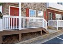 Small front porch with a wooden railing and red door at 3607 Ginnis Sw Dr # 7, Atlanta, GA 30331