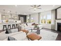 Open floor plan with a large kitchen island and adjacent living area at 106 Delilah St, Mcdonough, GA 30252