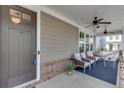 Covered front porch with seating, ceiling fans, and a hammock at 3159 Lantana Way, Buford, GA 30519