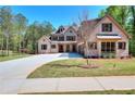 Gorgeous two-story brick home featuring a lush lawn, long driveway, and a three-car garage at 43 Iroquois Ct, Covington, GA 30014