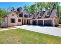 Spacious brick home with a three-car garage, wide driveway, and well-maintained lawn at 43 Iroquois Ct, Covington, GA 30014