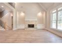 Bright living room featuring hardwood floors and stone fireplace with built-ins at 43 Iroquois Ct, Covington, GA 30014