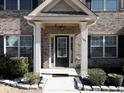 Inviting front entrance with brick facade and black front door at 325 Allgood Trce, Acworth, GA 30101