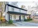 Two-story house with white siding, gray accents, and a covered porch at 1506 Avon Sw Ave, Atlanta, GA 30311