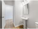 Clean and bright bathroom with pedestal sink and a mirror at 7140 Brushwood Bend (Lot 107), Lithonia, GA 30058