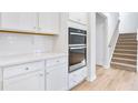 Modern kitchen with white cabinets, double oven, and quartz countertops at 108 Aj Welch Jr Way, Mcdonough, GA 30252