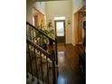 Bright entryway with hardwood floors, staircase, and potted plants at 2496 Osceola Rd, Lithonia, GA 30058