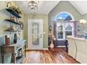 Elegant entryway featuring hardwood floors, a glass door, and decorative accents at 430 Flowering Trl, Grayson, GA 30017