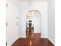 Hallway with hardwood floors leads to a white kitchen with stainless steel appliances at 2499 Peachtree Ne Rd # 504, Atlanta, GA 30305