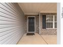 Covered front porch with gray siding and brick accents at 1187 Warm Spring Ct, Hampton, GA 30228