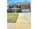 Charming two-story brick home with well-maintained lawn and a two-car garage at 5030 Mundy Dr, Cumming, GA 30028