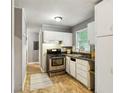 Kitchen boasts white cabinets and stainless steel appliances at 516 Fairlane Nw Cir, Atlanta, GA 30331