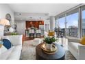 Open concept living room and kitchen with hardwood floors and city views at 1080 Peachtree Ne St # 3309, Atlanta, GA 30309