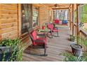 Relaxing front porch with wicker rocking chairs and red cushions at 135 Fiddle Crk, Social Circle, GA 30025
