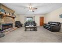 Comfortable living room with a stone fireplace and neutral carpet at 175 Highland Cir, Mcdonough, GA 30253