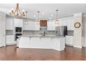 Gourmet kitchen with white cabinets, stainless steel appliances, granite countertops, and a large central island with a sink at 333 Gardens Of Harmony Dr, Canton, GA 30115