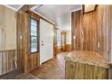 Front entry with wood paneling and a view to the living room at 1265 Glenbrooke Cv, Lawrenceville, GA 30045