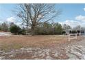 Spacious front yard with large tree and partial fencing at 1265 Glenbrooke Cv, Lawrenceville, GA 30045