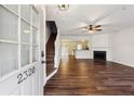 Hardwood floors lead to fireplace, staircase and front door in this bright living room at 2320 Whitestone Pl, Alpharetta, GA 30005