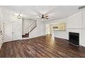 Spacious living room with hardwood floors, fireplace, and staircase access at 2320 Whitestone Pl, Alpharetta, GA 30005