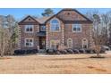 Handsome brick-faced two-story home boasts manicured landscaping and a well-maintained lawn at 2625 Lake Erma Dr, Hampton, GA 30228