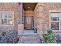 Charming covered front entrance featuring brick columns and decorative landscaping at 2625 Lake Erma Dr, Hampton, GA 30228