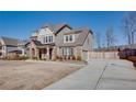 Stylish home with a long driveway, gray siding, brick accents and well-maintained landscaping at 5015 Montes Ln, Cumming, GA 30040