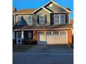 Two-story house with gray siding, brick accents, and a two-car garage at 28 Samuel Nw Way, Cartersville, GA 30121