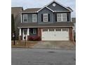 Two-story house with gray siding, brick accents, and a two-car garage at 28 Samuel Nw Way, Cartersville, GA 30121