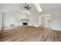 Spacious living area with vaulted ceiling, fireplace, and hardwood floors at 332 Stonecutters Cv, Stockbridge, GA 30281