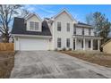 Two-story house with a neutral exterior, a large driveway, and a spacious yard at 537 N Cedar N Ct, Riverdale, GA 30274